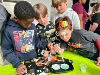 elementary students experiment with hydrophobic sand