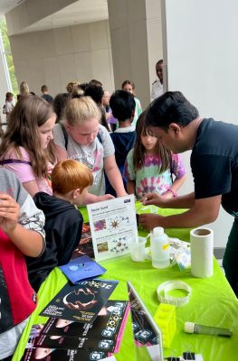 Bipin explains a demo to elementary students