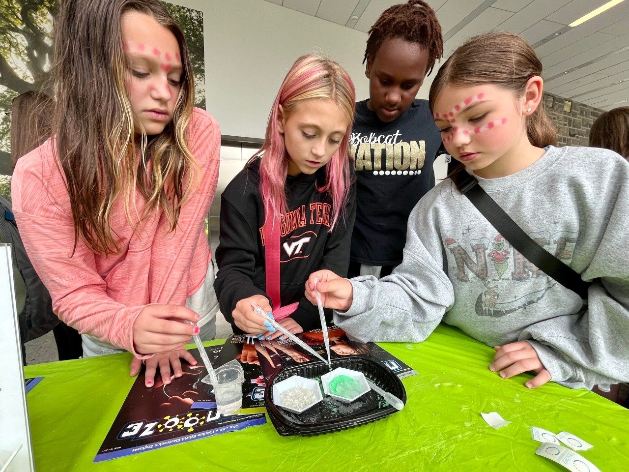 elementary students experiment with hydrophobic sand