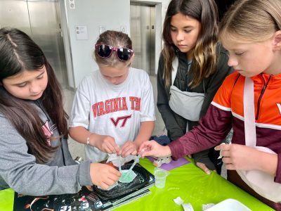 elementary students experiment with hydrophobic sand