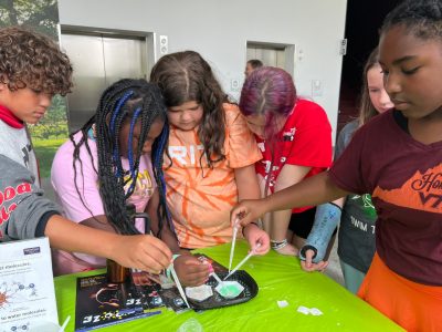 elementary students experiment with hydrophobic sand