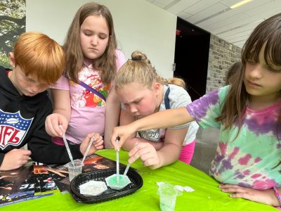 Elementary students experiment with hydrophobic sand