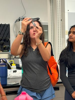 student uses magnet on ferrofluid