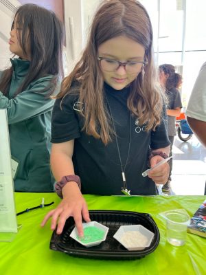 A student compares hydrophobic nano-sand to regular sand