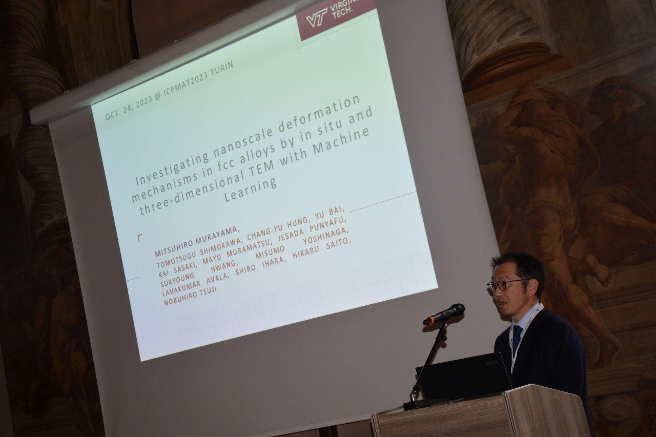 Mitsuhiro Murayama gives a presentation at a conference