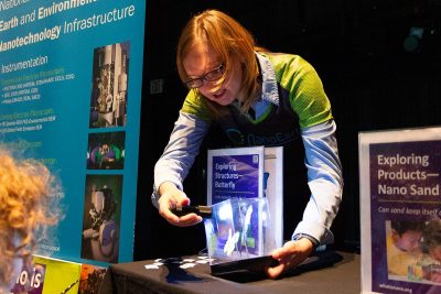 Tonya Pruitt using a flashlight to demonstrate structural color on a butterfly