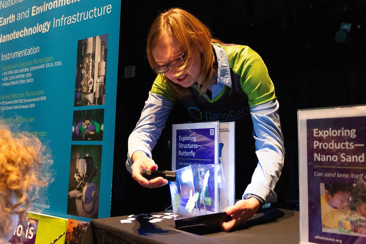 Tonya Pruitt using a flashlight to demonstrate structural color on a butterfly