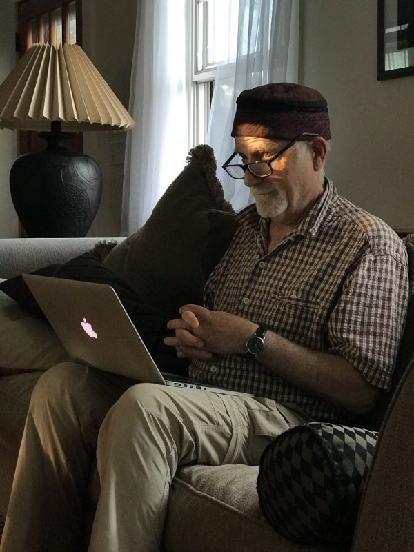 Jim Metzner in Cape Cod with his laptop and hat