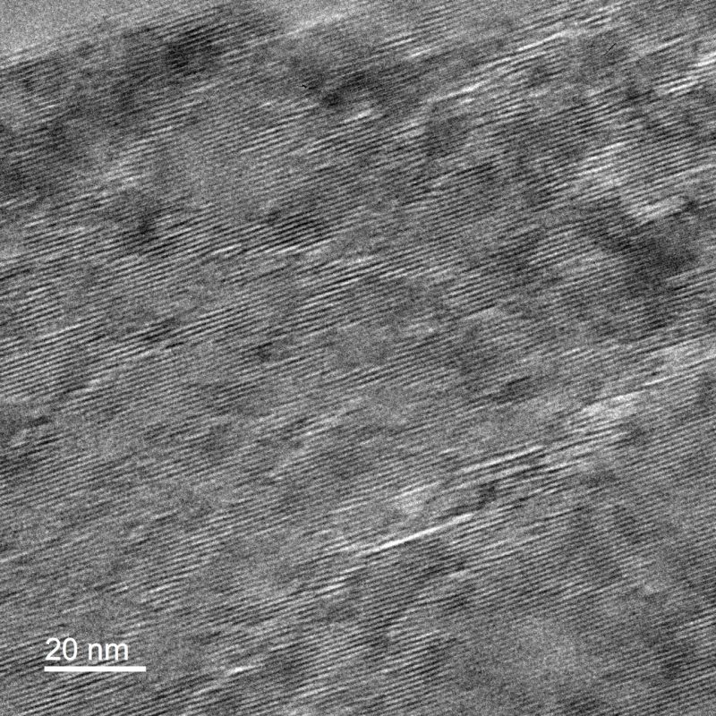 TEM image showing faint diamond and V-shaped arrays in a layer silicate mineral (phengite) indicative of ripplocations