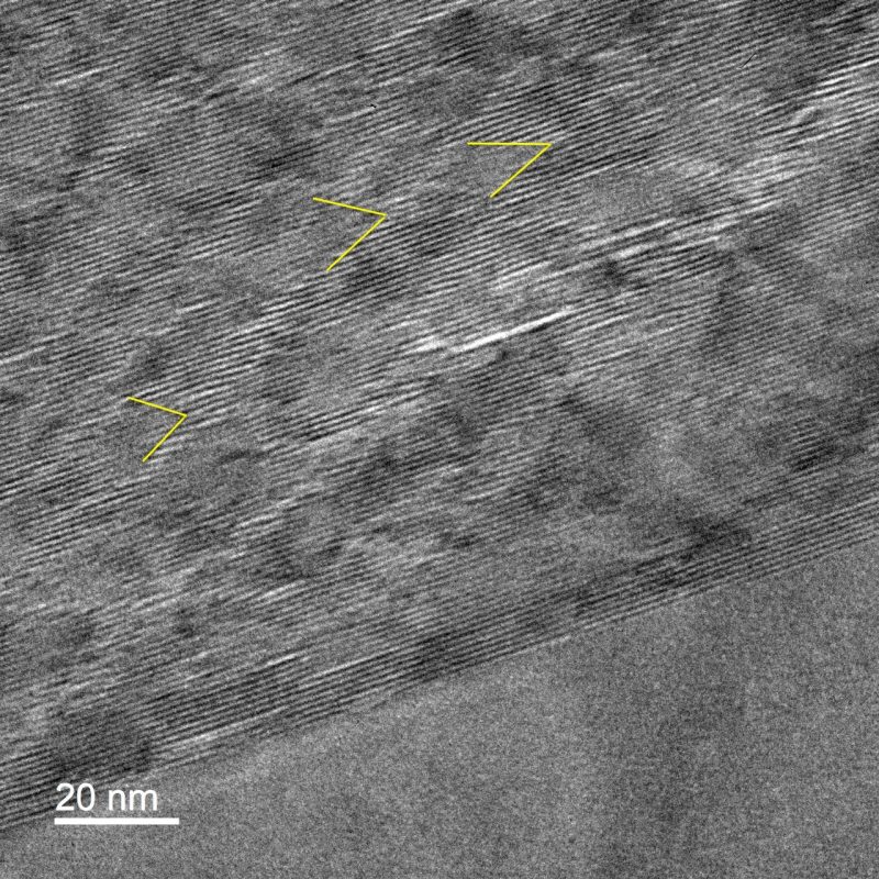 TEM image showing faint diamond and V-shaped arrays in a layer silicate mineral (phengite) indicative of ripplocations